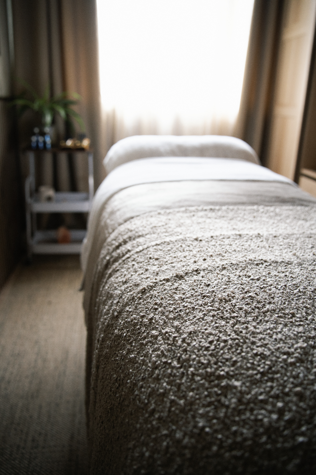A calm, sunlit treatment room prepared for a Manual Lymphatic Drainage session